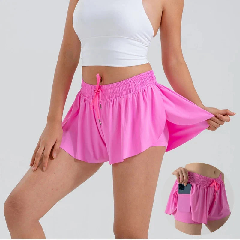 Women wearing pink 2 in 1 flowy sports shorts with pockets for running and yoga