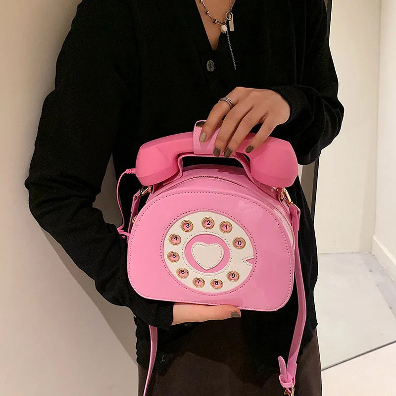 Pink women's creative shoulder bag shaped like a retro telephone with PU leather and crossbody strap
