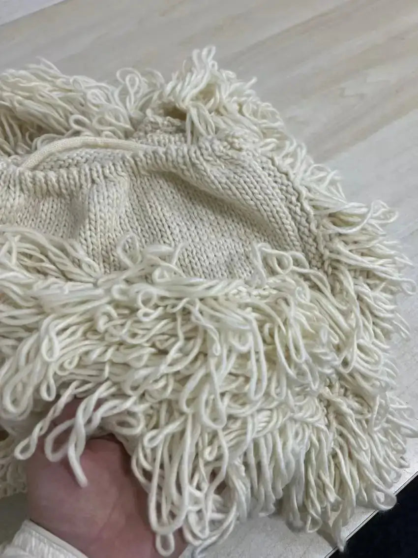 Joskaa knitted tassels fabric detail in cream color.