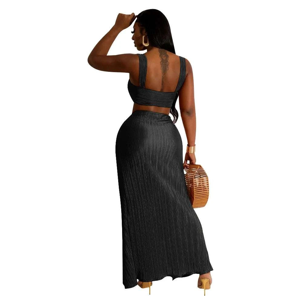 Summer two-piece set with a sexy backless halter top and high waist side slit pleated skirt, ideal for beach streetwear.