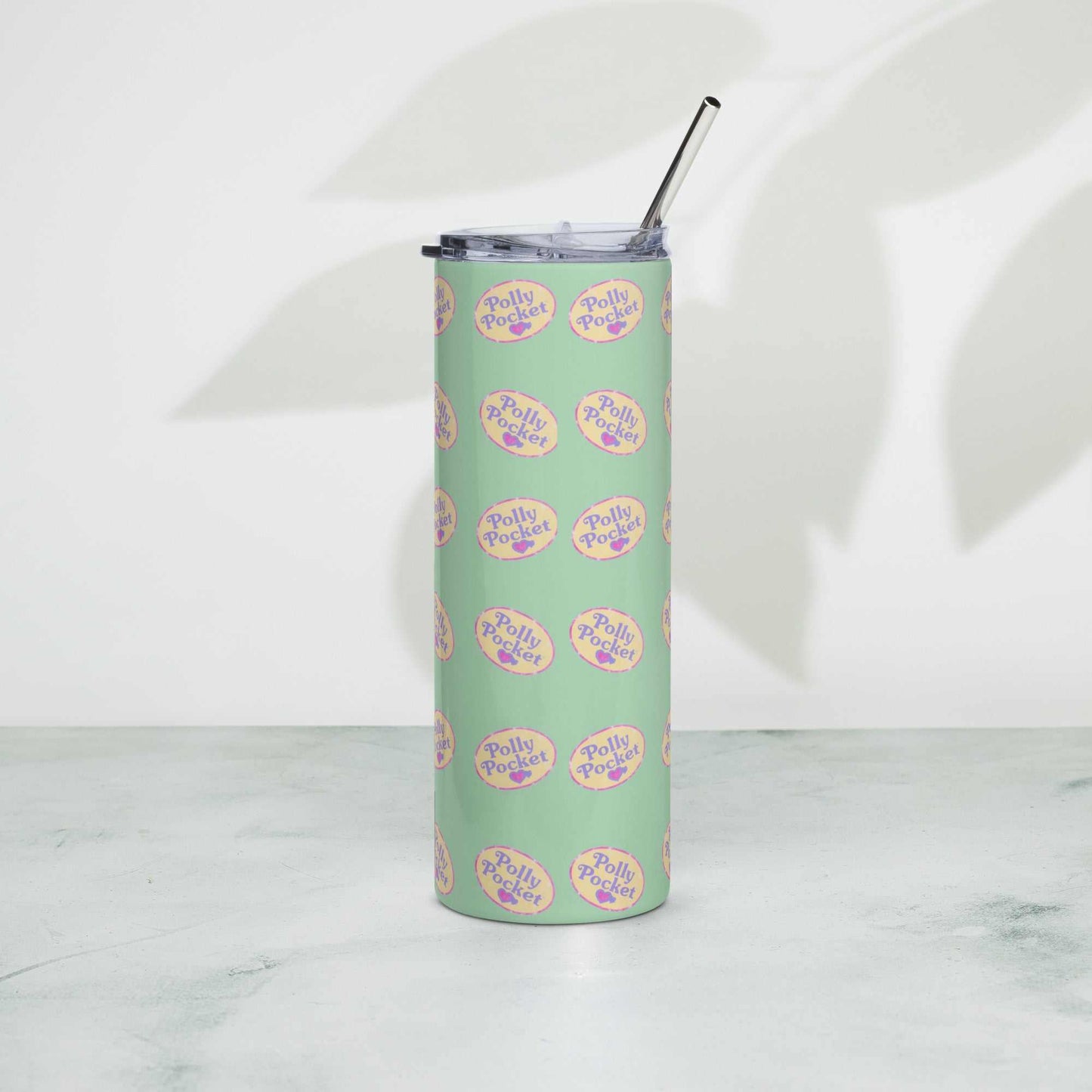 Polly Pocket tumbler with metal straw and lid on white surface.