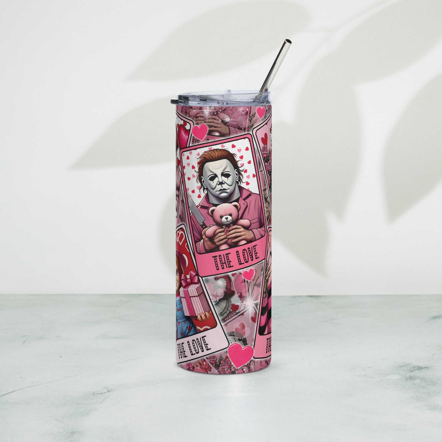 Stainless steel tumbler with artistic design, lid, and metal straw.