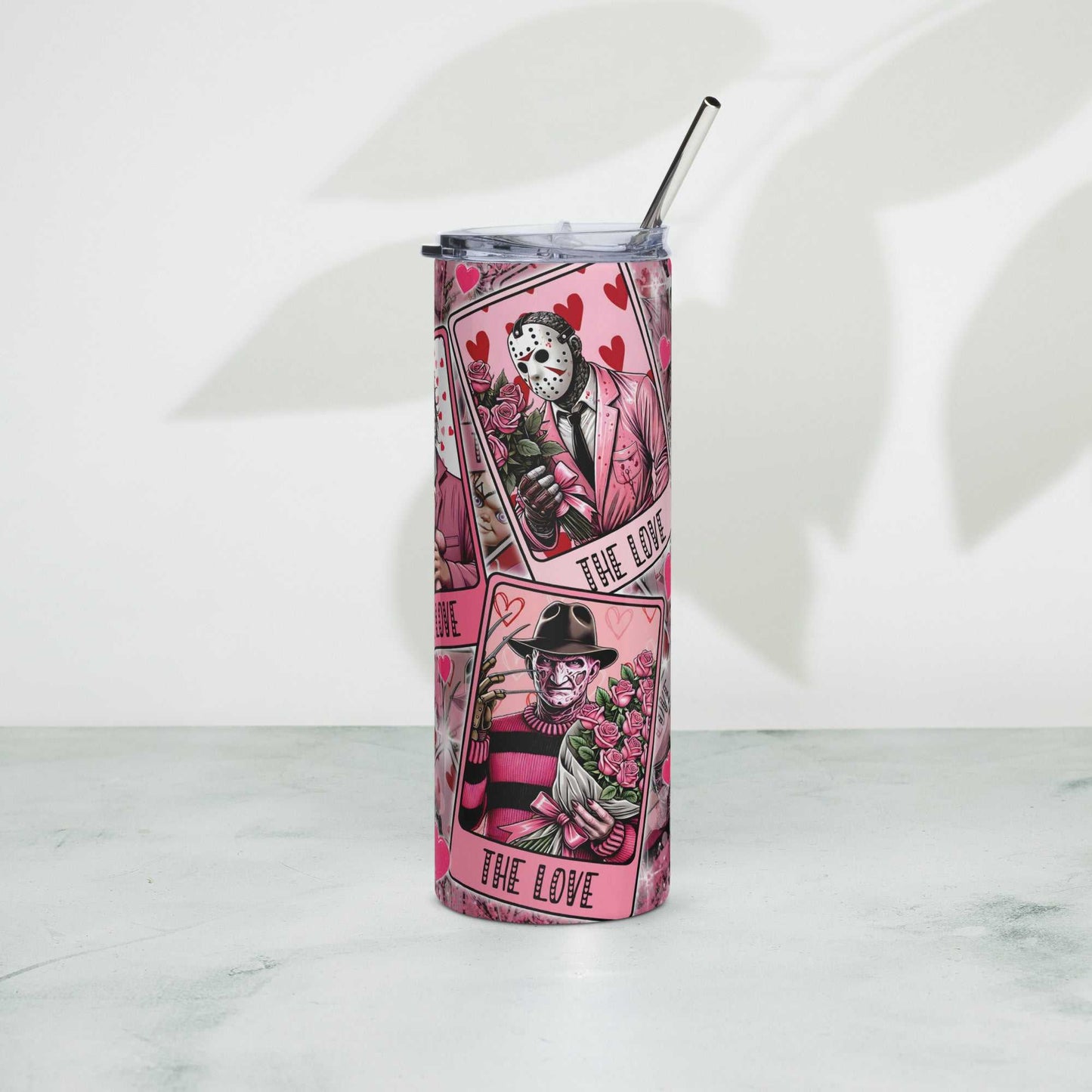 Stainless steel tumbler with metal straw and playful design, 20 oz capacity, ideal for hot or cold drinks.