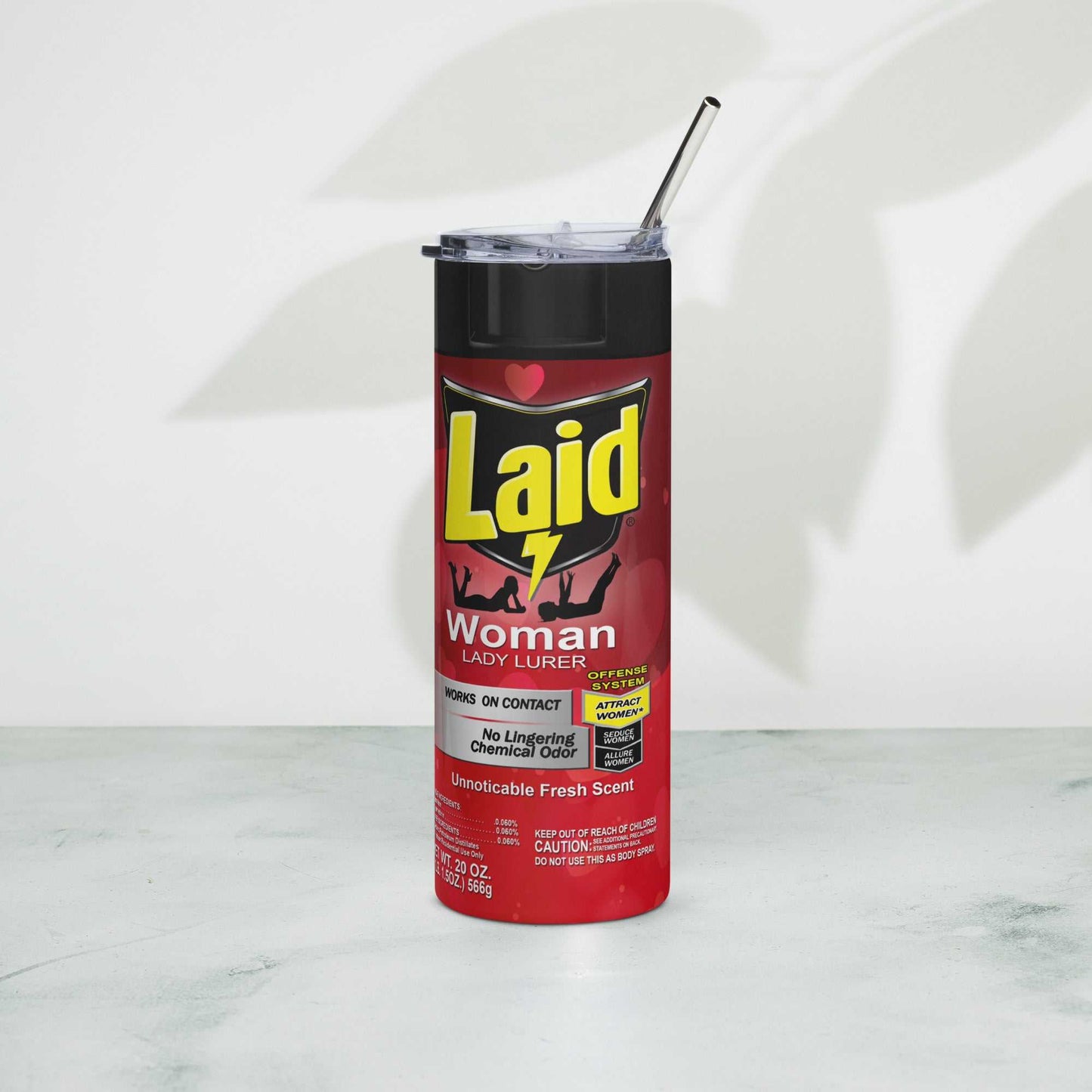 LAID Spray Can stainless steel tumbler with metal straw on a marble surface.