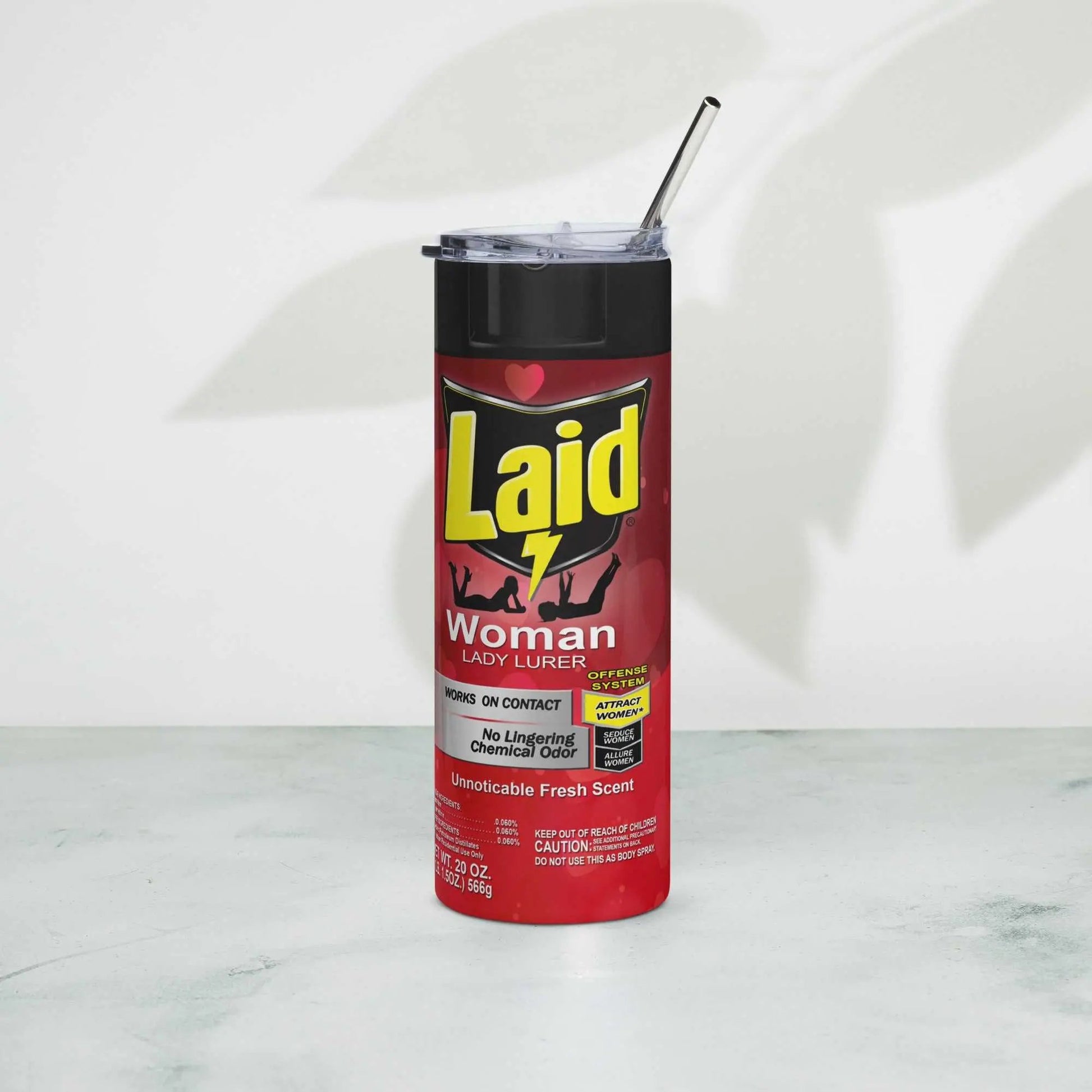 LAID Spray Can stainless steel tumbler with metal straw on a marble surface.