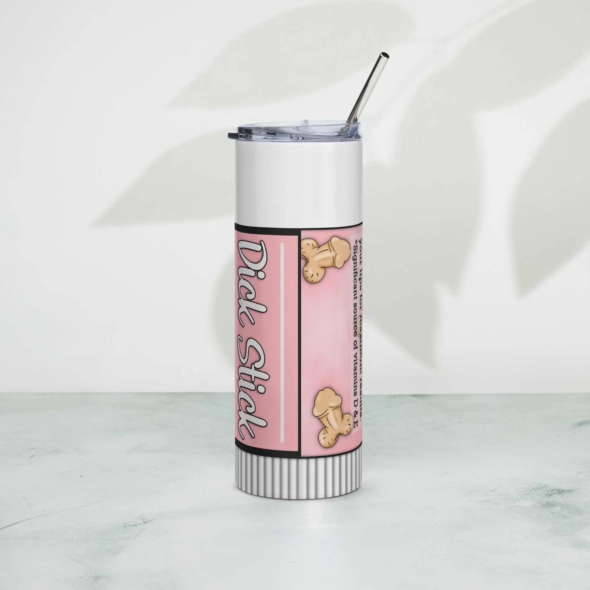 Stainless steel tumbler with lid and straw on a white surface, featuring a pink design.