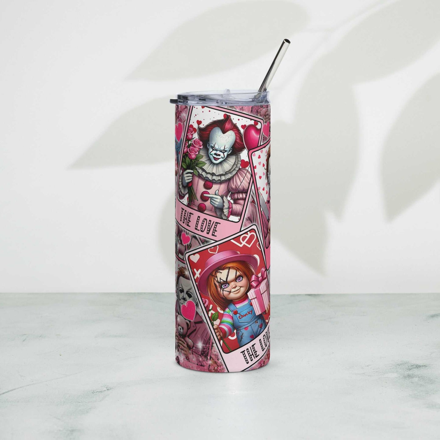 Stainless steel tumbler with colorful design and metal straw.