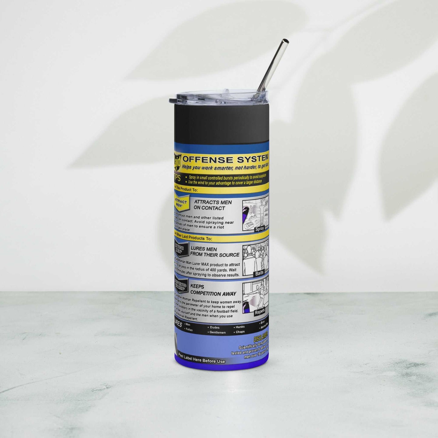 LAID Spray Can stainless steel tumbler with metal straw on table.