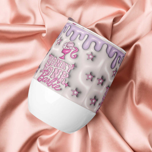 12 oz stainless steel wine tumbler with purple drip design and pink text on white background, placed on pink satin fabric
