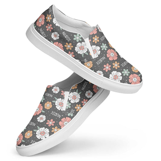 Women’s slip-on canvas shoes with floral pattern and "NURSE" text, featuring white rubber soles and elastic side accents for comfort.