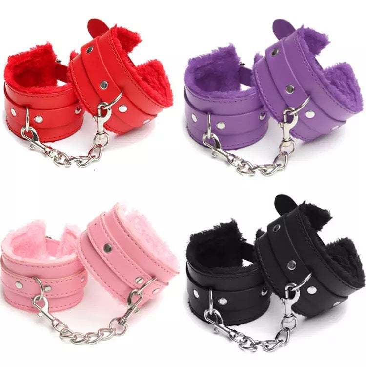 SM handcuffs in red, purple, pink, and black with soft plush lining for BDSM bondage restraints.