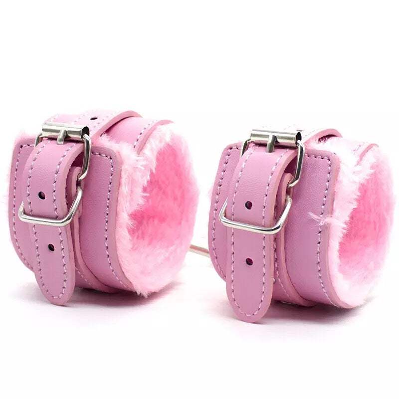 Pink plush BDSM handcuffs and ankle cuffs for adult erotic games and bondage.
