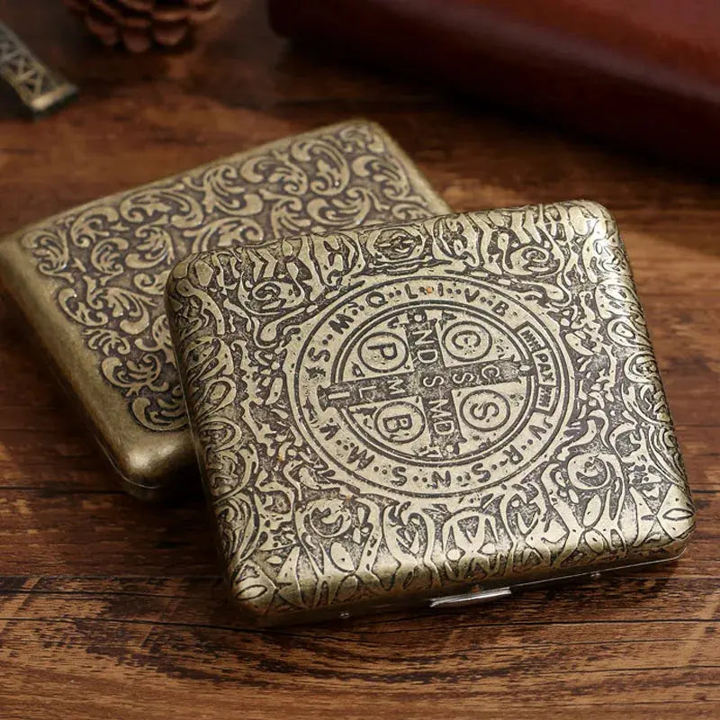 Vintage metal cigarette case with intricate classic design, holds 20 cigarettes, ideal for men; lacquered finish.