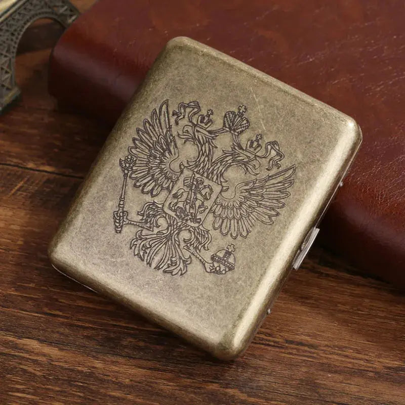 Vintage metal cigarette case with embossed classic design, holds 20 cigarettes.