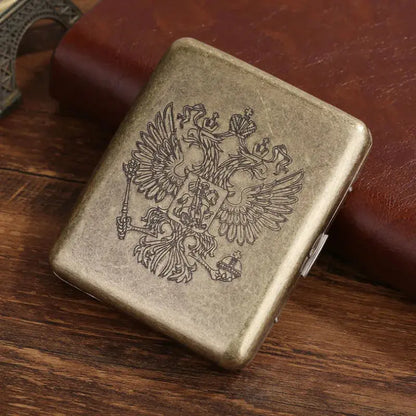 Vintage metal cigarette case with embossed classic design, holds 20 cigarettes.