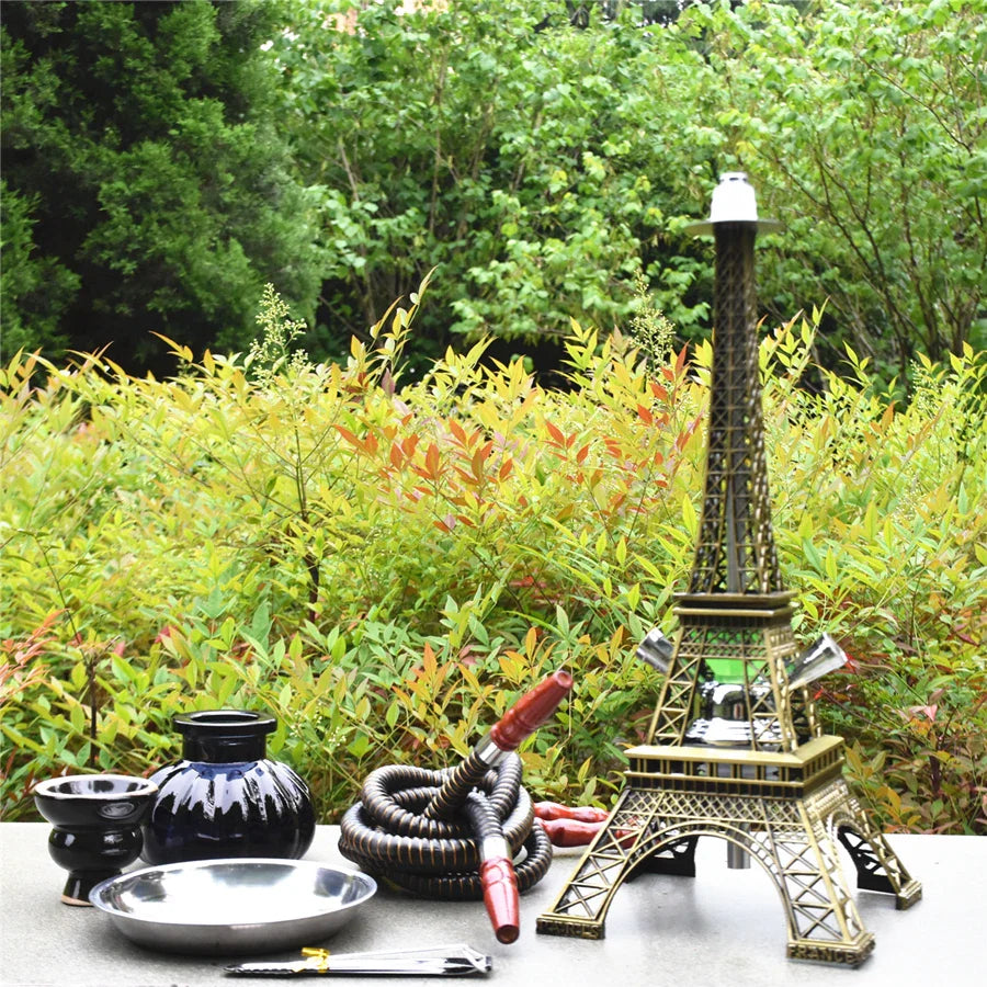 Paris Tower Shisha Hookah with double hose, ceramic bowl, charcoal tongs, and acrylic base in outdoor setting.