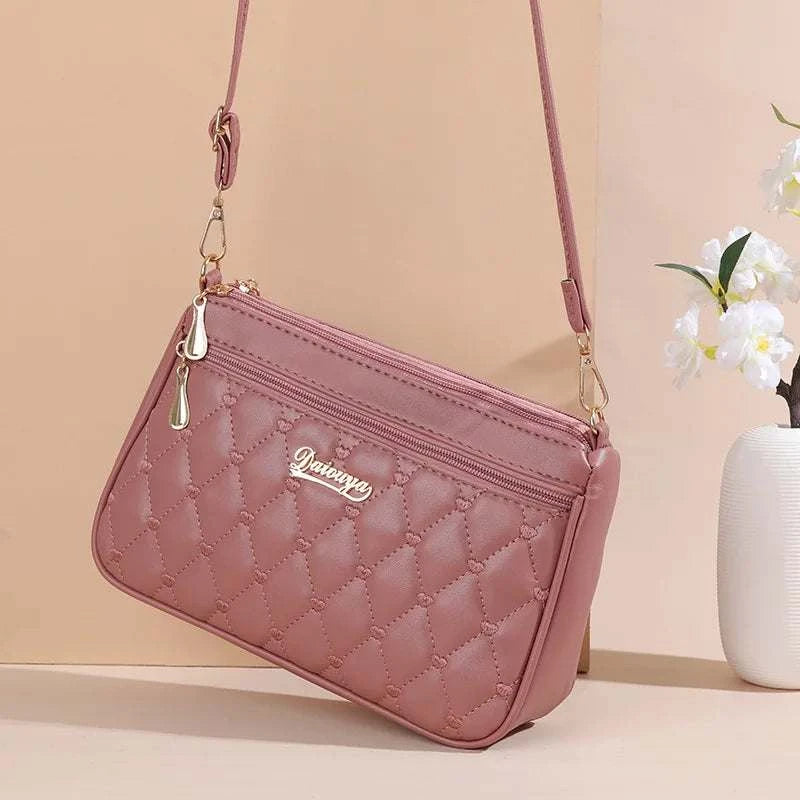 Pink PU leather crossbody bag with quilted embroidery and gold-tone zipper detail for women