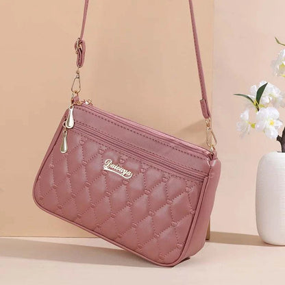 Pink PU leather crossbody bag with quilted embroidery and gold-tone zipper detail for women