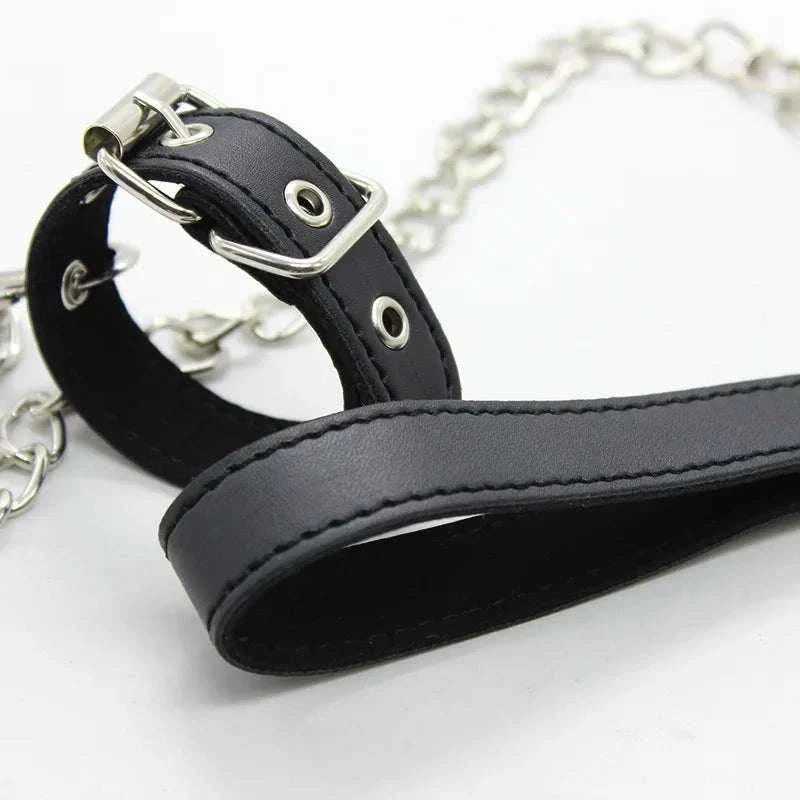 Black leather penis ring with metal chain for fetish bondage and BDSM training.
