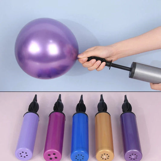 Handheld balloon pump inflating a purple balloon with multiple colored balloon pumps displayed below.