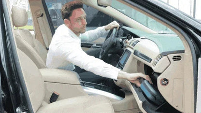 Man using a bicycle seat look-alike massager for men and women in a car, illustrating portability and convenience.
