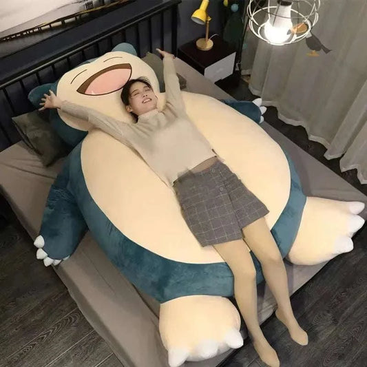 200/150cm Aoger giant Snorlax plush toy pillow in blue and cream with a person lying on it in a bedroom setting