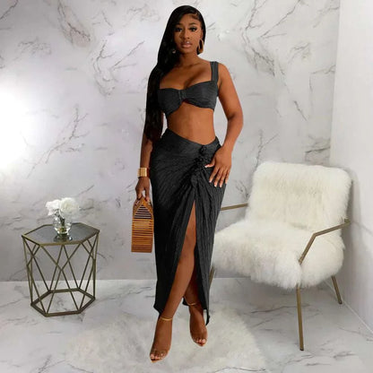 Summer two-piece set with backless halter top and high waist side slit pleated skirt for women.
