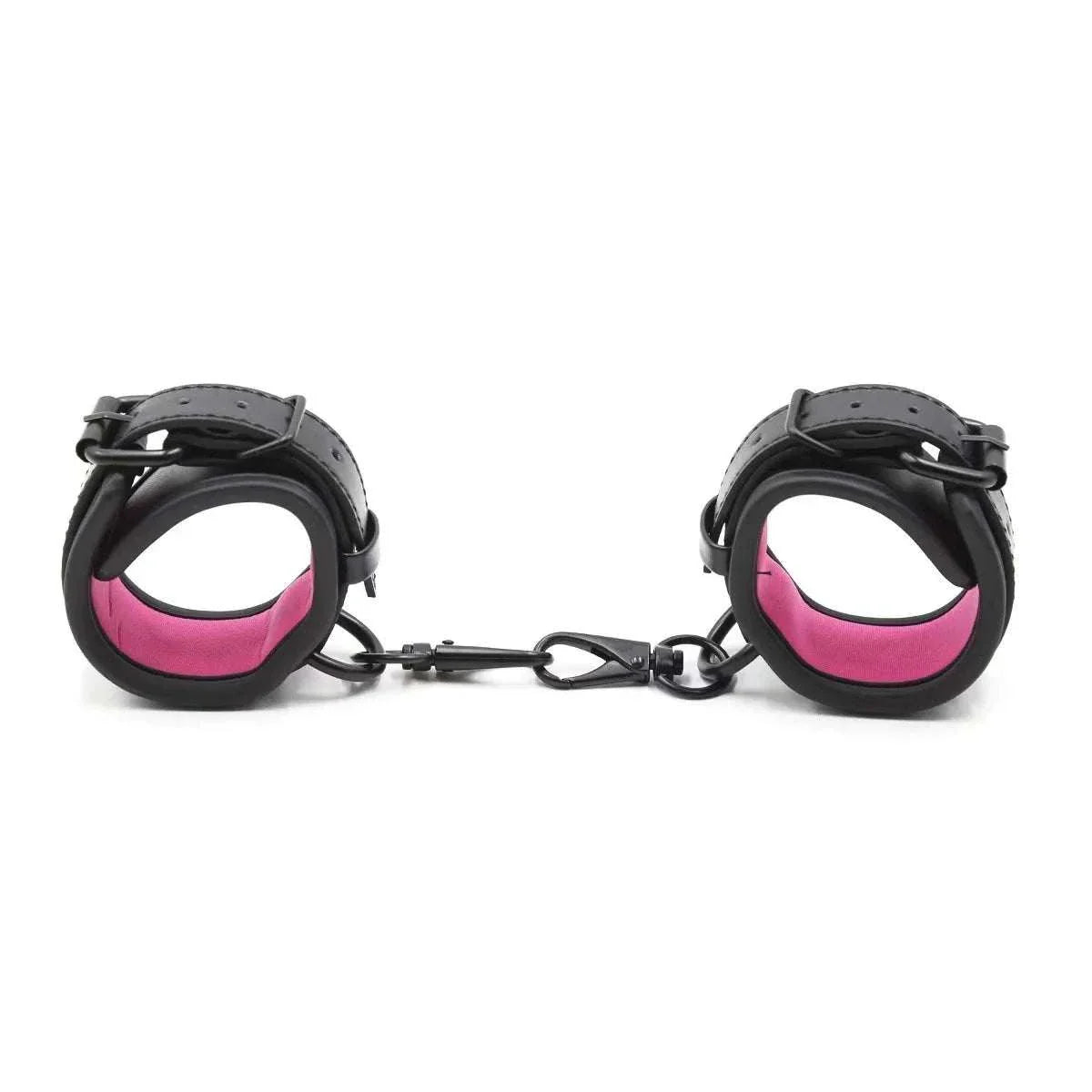 SM erotic leather handcuffs and footcuffs in black and pink for bondage and BDSM play.