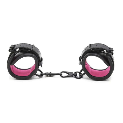 SM erotic leather handcuffs and footcuffs in black and pink for bondage and BDSM play.