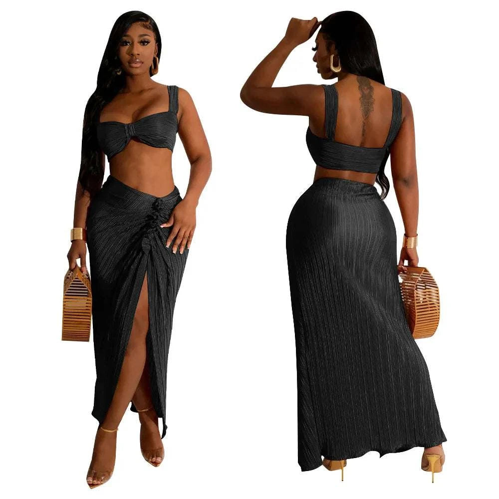 Summer women's two-piece set with backless halter top and high waist side slit pleated skirt.