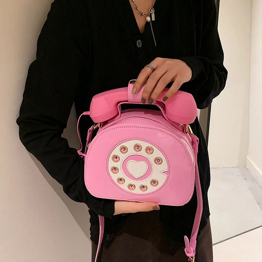 Pink women's creative shoulder bag shaped like a retro telephone with PU leather and crossbody strap