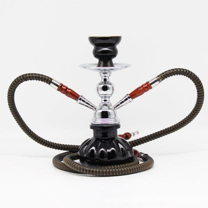 Small glass shisha pipe with hose and charcoal tongs.