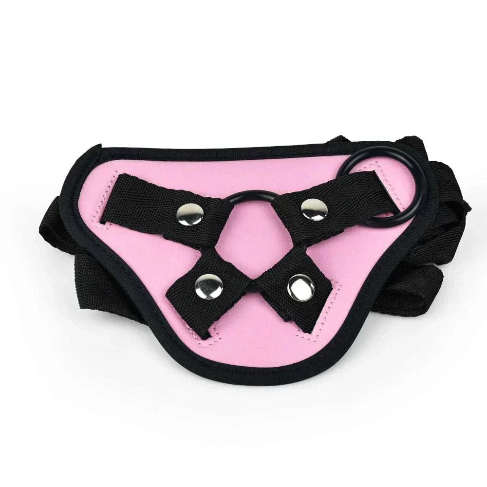 Adjustable pink strap-on harness with black straps for bondage use.