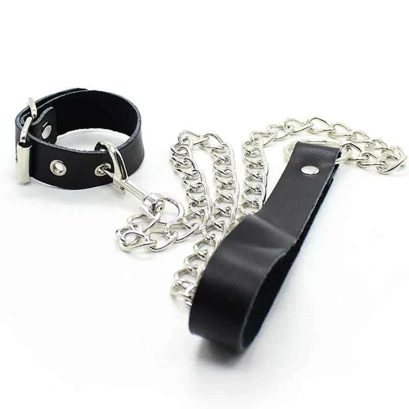 Leather penis ring with metal chain and scrotal cuff for BDSM training.