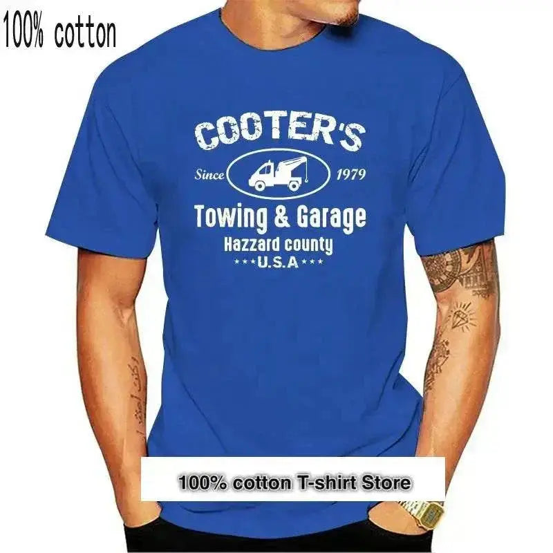 Blue cotton T-shirt with "Cooter's Towing & Garage Hazzard County USA" print.