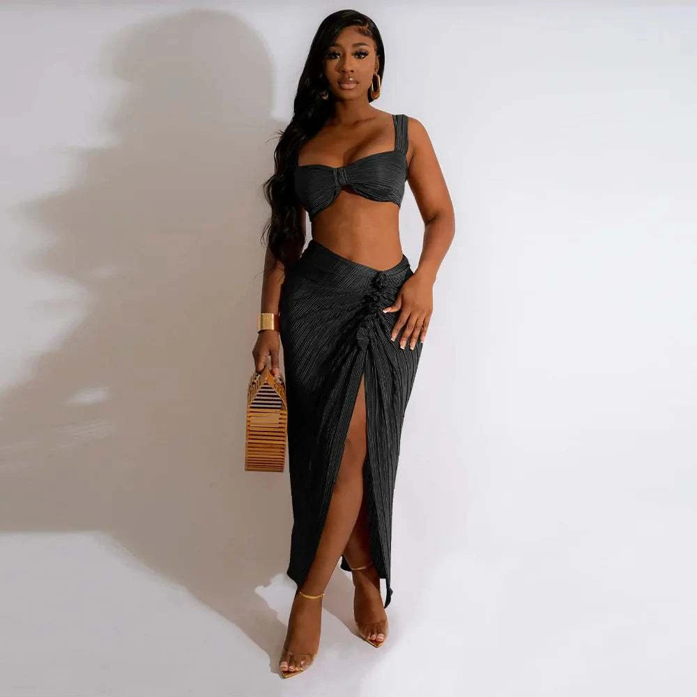 Summer two-piece set with backless halter top and high waist side slit pleated skirt for women.