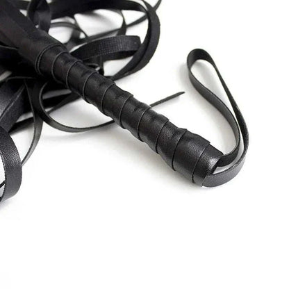 BDSM leather flogger whip with a wrapped handle for adult games and erotic play.