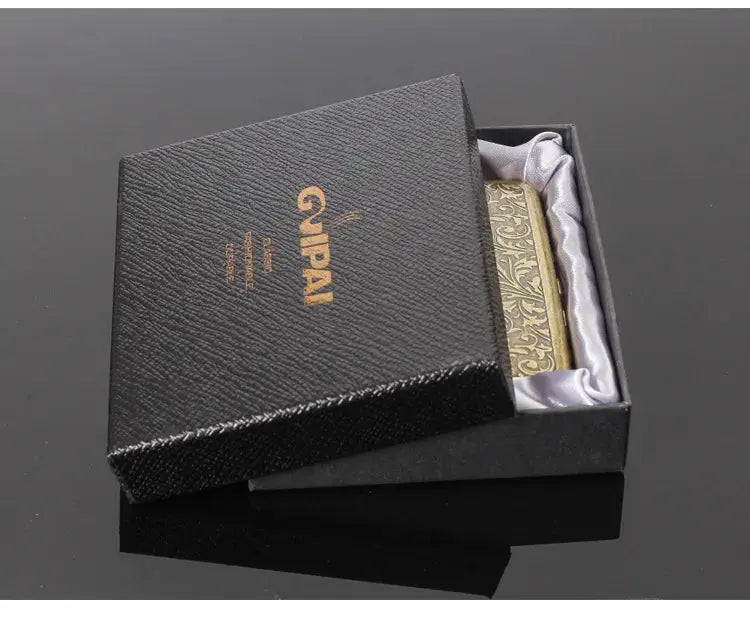 Retro brass cigarette box in a black gift box with decorative detailing.