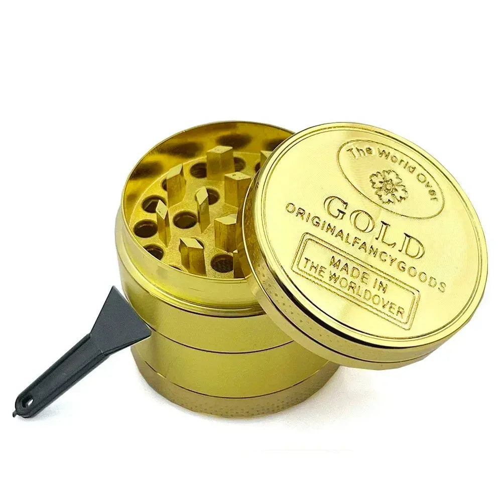 Gold herb grinder with open compartments and a small scraper, made of zinc alloy, 40mm size.