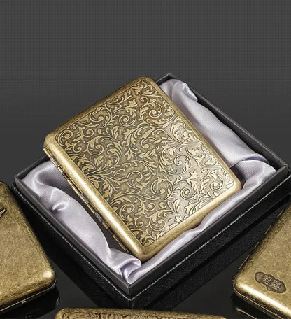 Retro brass cigarette box with ornate design in a gift box.