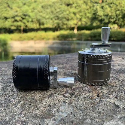 4-layer zinc alloy herbal grinder, black and silver options, outdoors on stone surface.