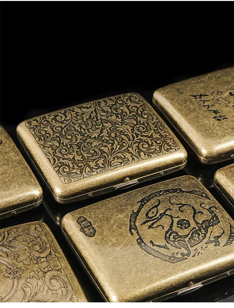 Retro brass cigarette box with intricate designs for tobacco storage.