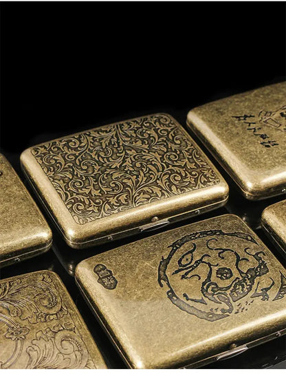 Retro brass cigarette box with intricate designs for tobacco storage.