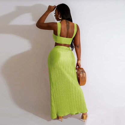 Summer dress set with backless halter top and high waist side slit pleated skirt in vibrant green.