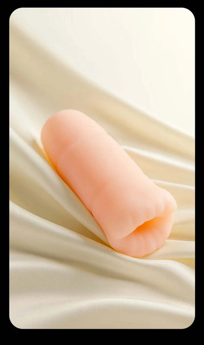 Men's automatic tongue licking oral sex toy on satin background.