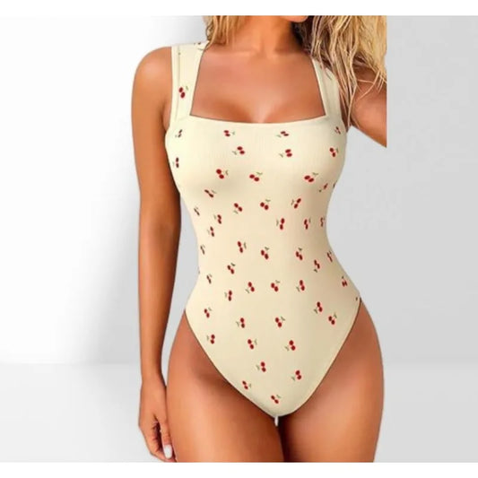 Beige bodysuit with red cherry pattern on a white background