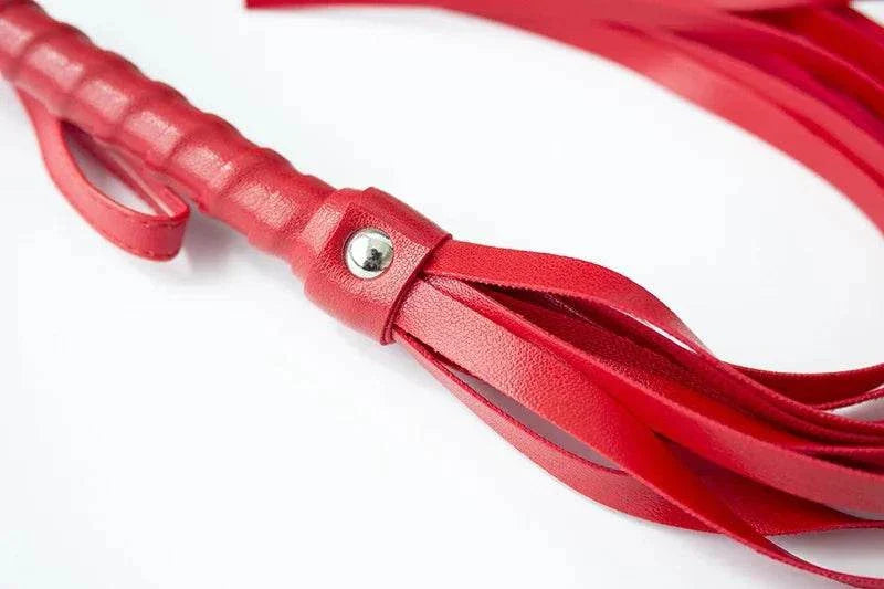 Red BDSM bondage flogger, erotic spanking accessory for adults.