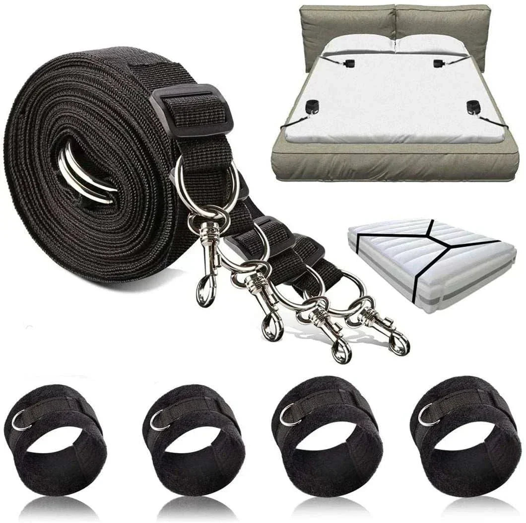 BDSM bondage restraint system with nylon handcuffs and ankle cuffs on a bed.
