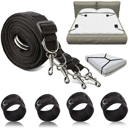 BDSM bondage restraint system with nylon handcuffs and ankle cuffs on a bed.