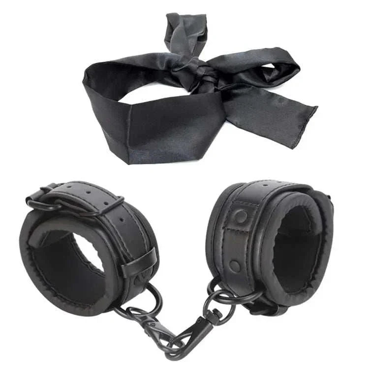 SM erotic leather handcuffs and footcuffs set for bondage and BDSM play.